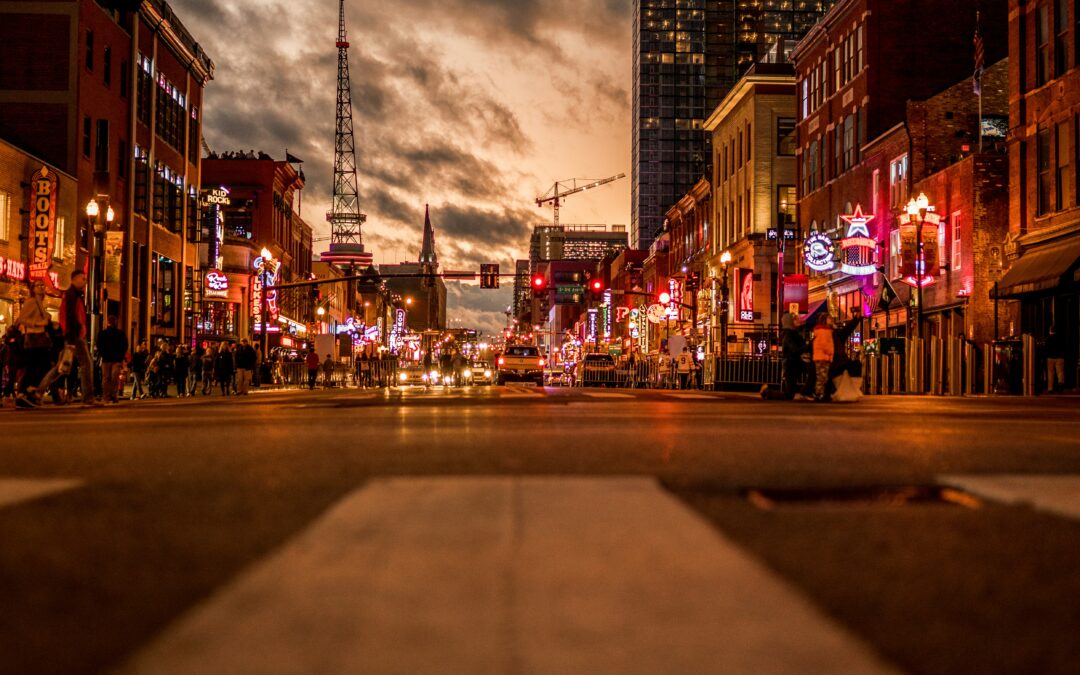 Cars on road at night between buildings in Nashville